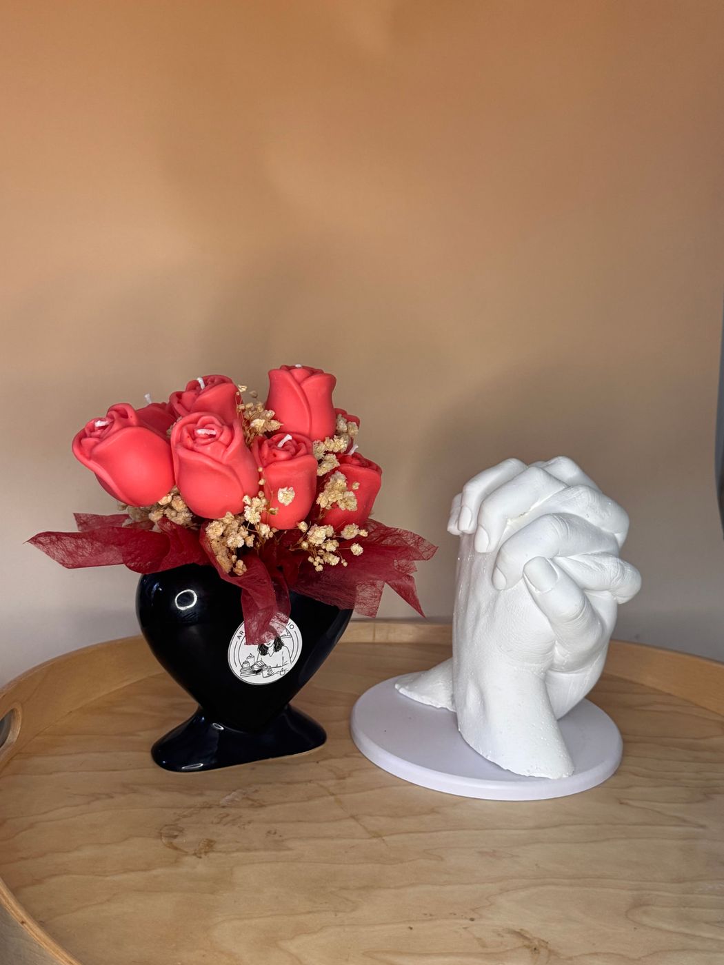 Bouquet de velas em forma de rosas vermelhas num vaso coração preto